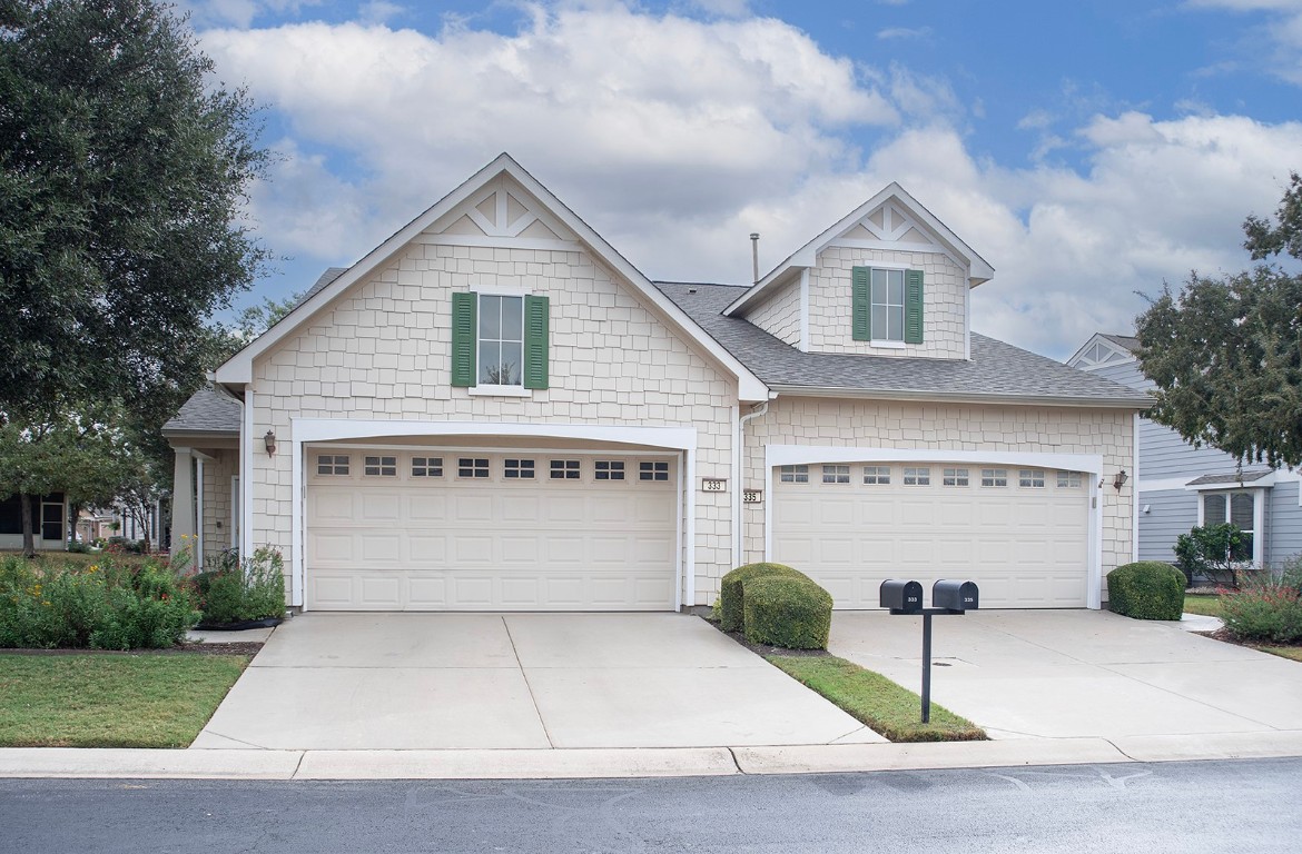 a view of house and outdoor space with garage