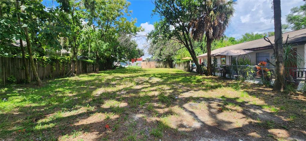 a backyard of a house with yard and trampoline