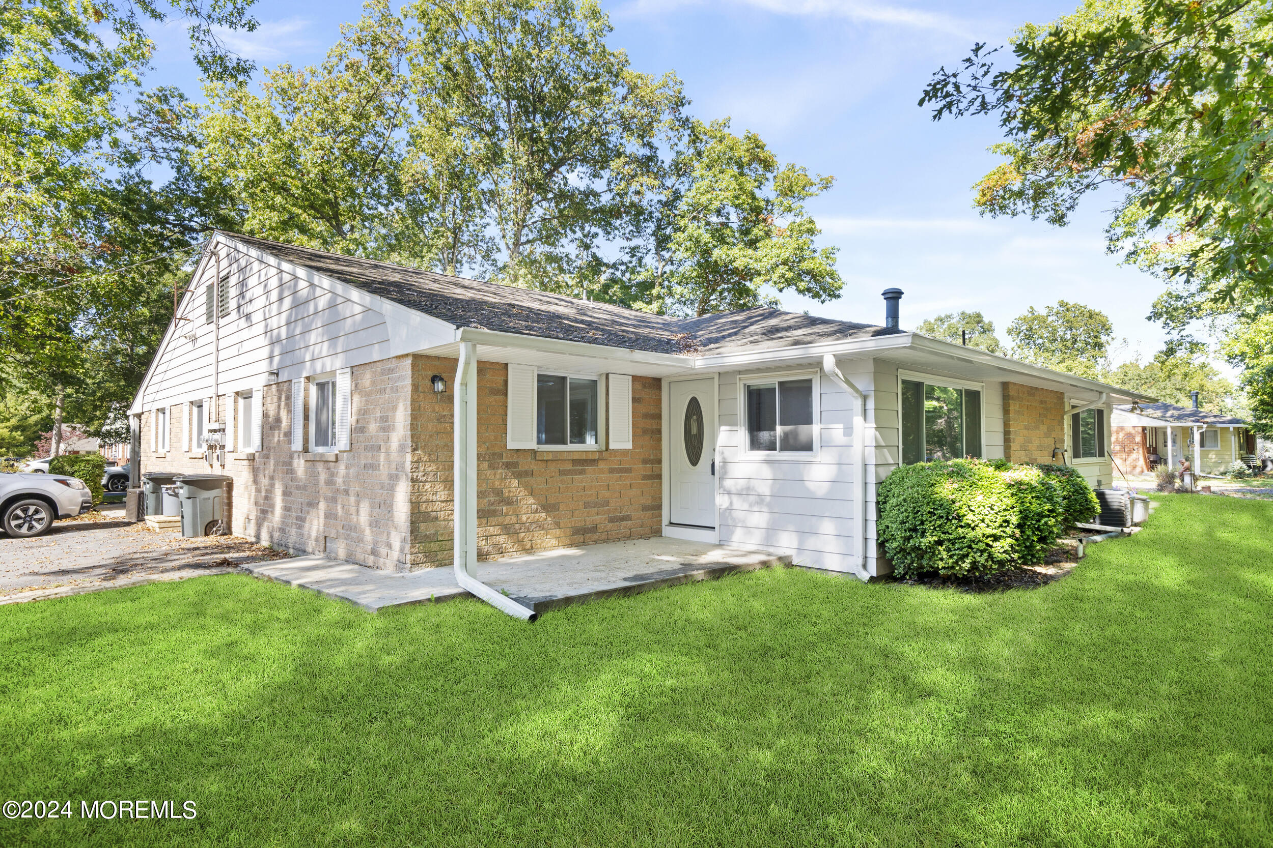 a front view of house with a garden and patio