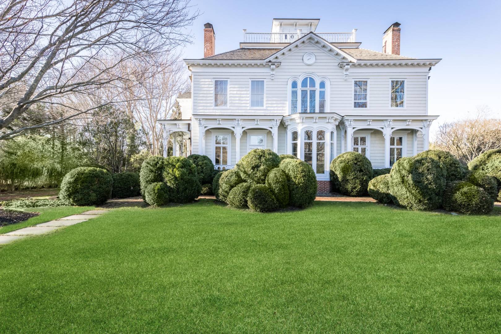 a front view of a house with a garden