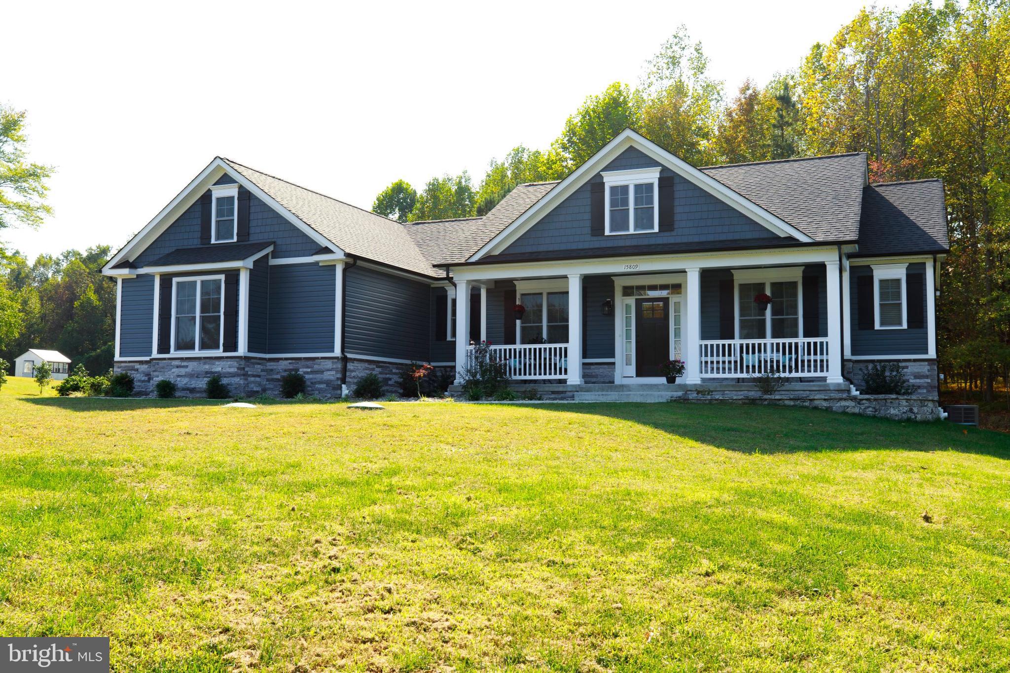 a front view of a house with swimming pool and porch