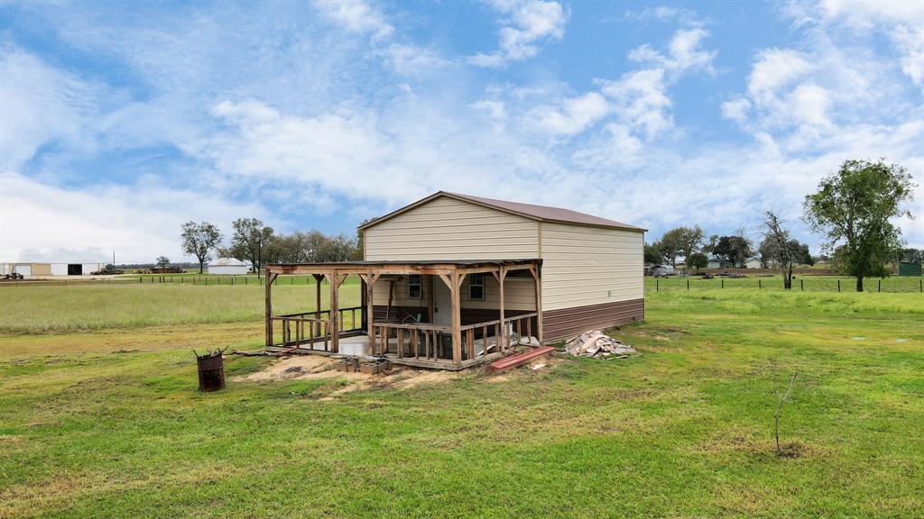 a view of a house with a yard and sitting area