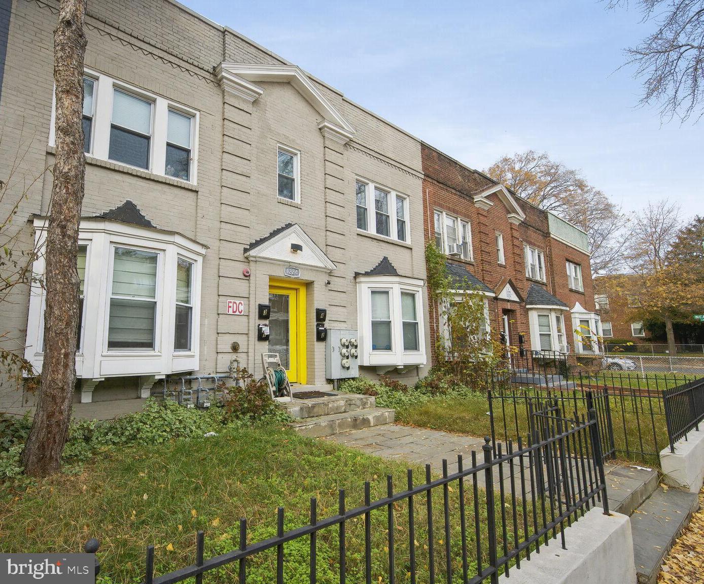 a view of a brick building next to a yard