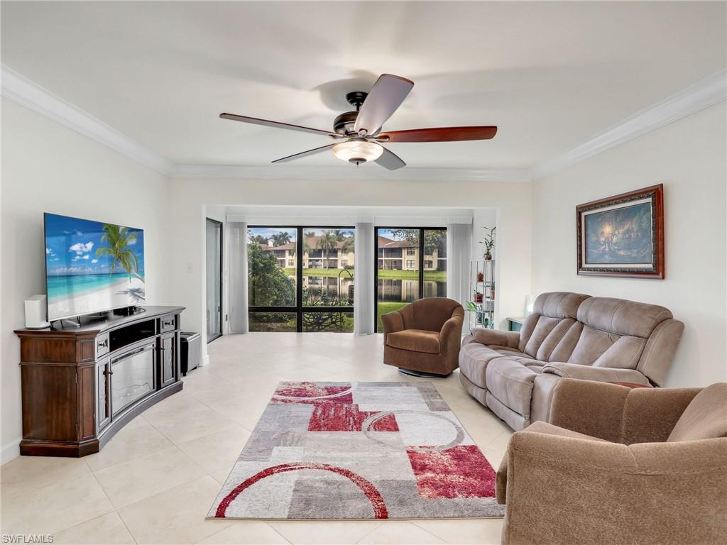 a living room with furniture ceiling fan and a rug