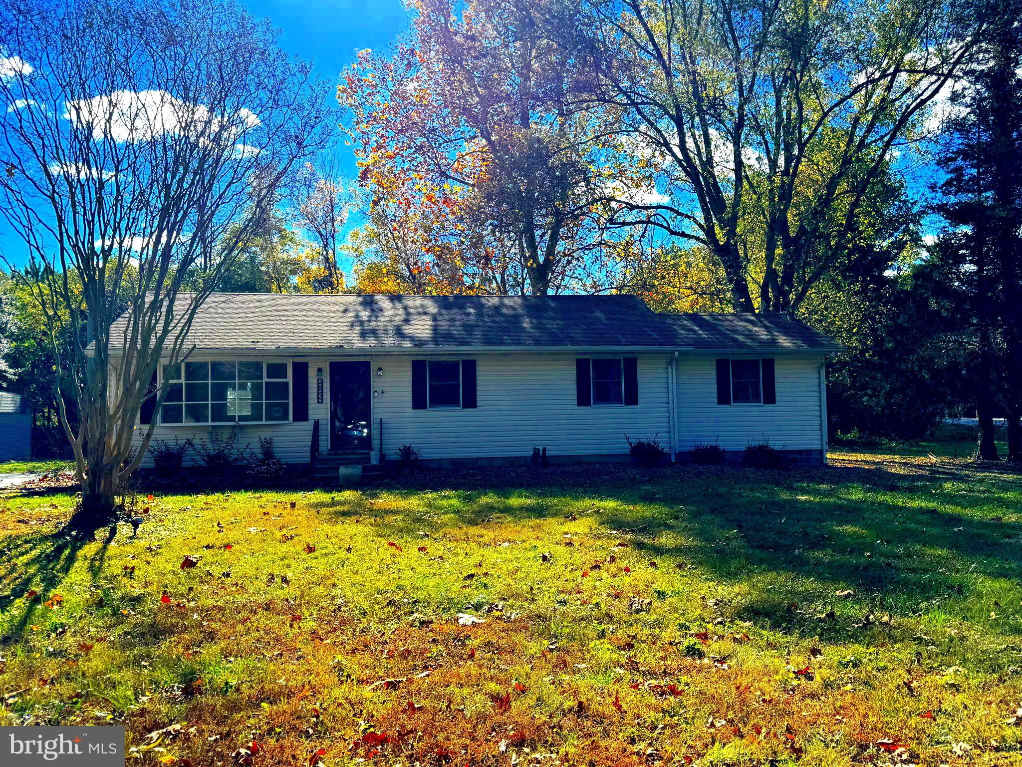 a view of a house with swimming pool next to a yard