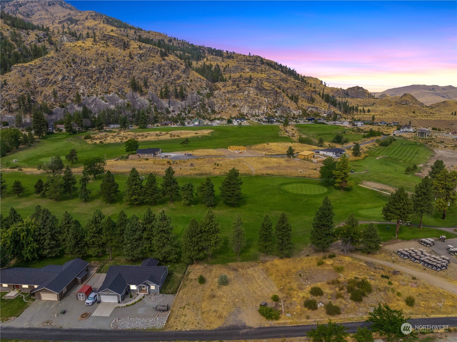 a view of a mountain with a yard