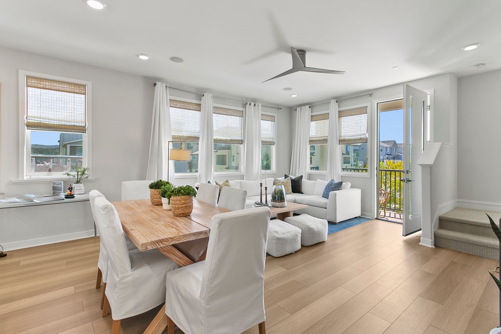 a living room with furniture and large windows