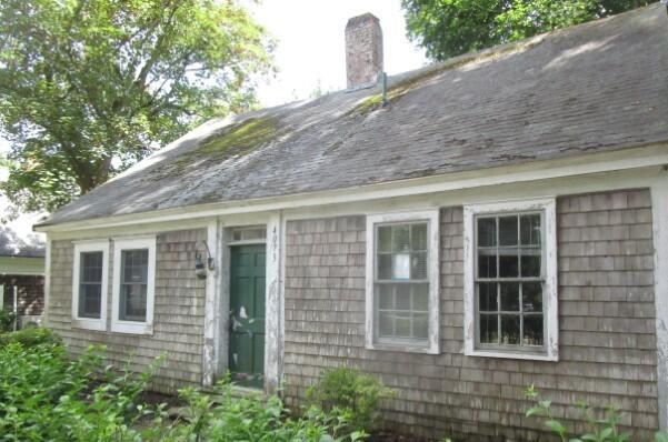 a view of a brick house with large windows