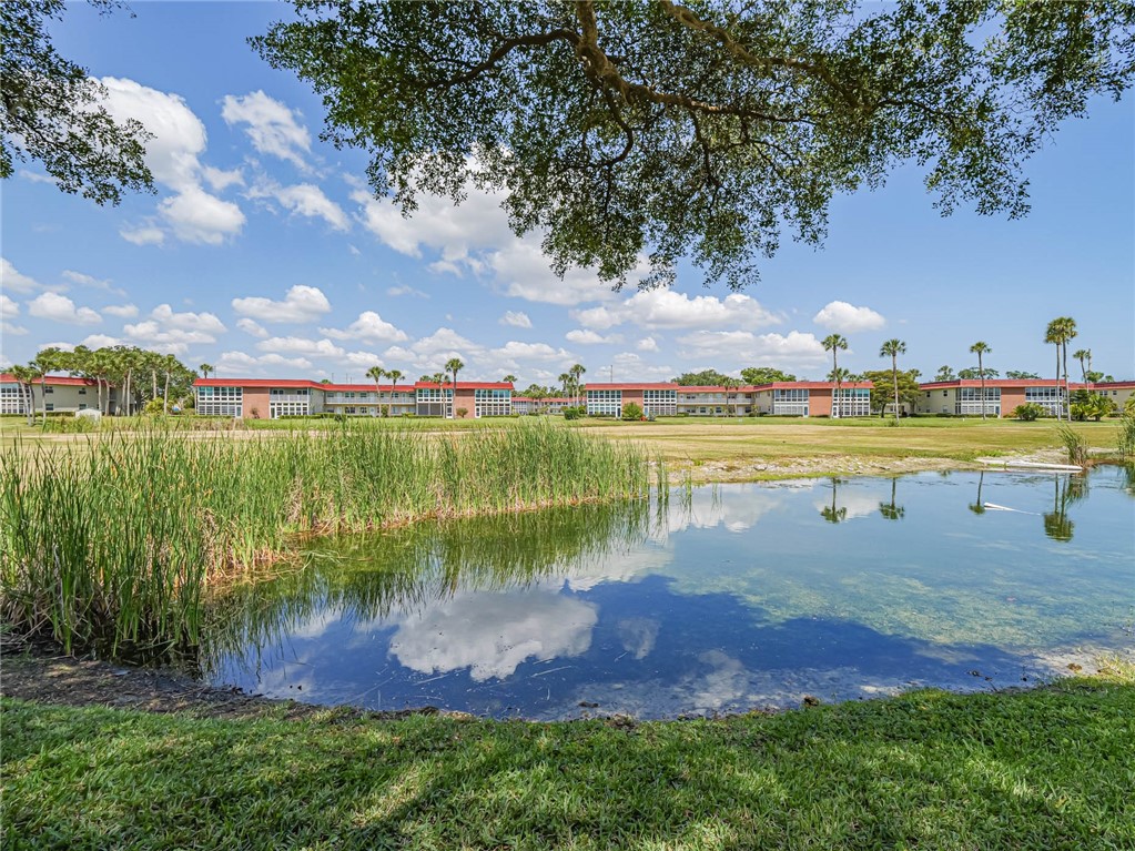 a view of a lake with houses in the back