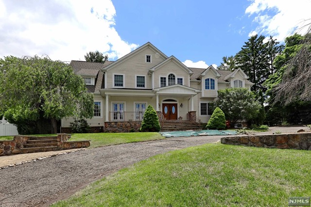 a view of house with yard and green space