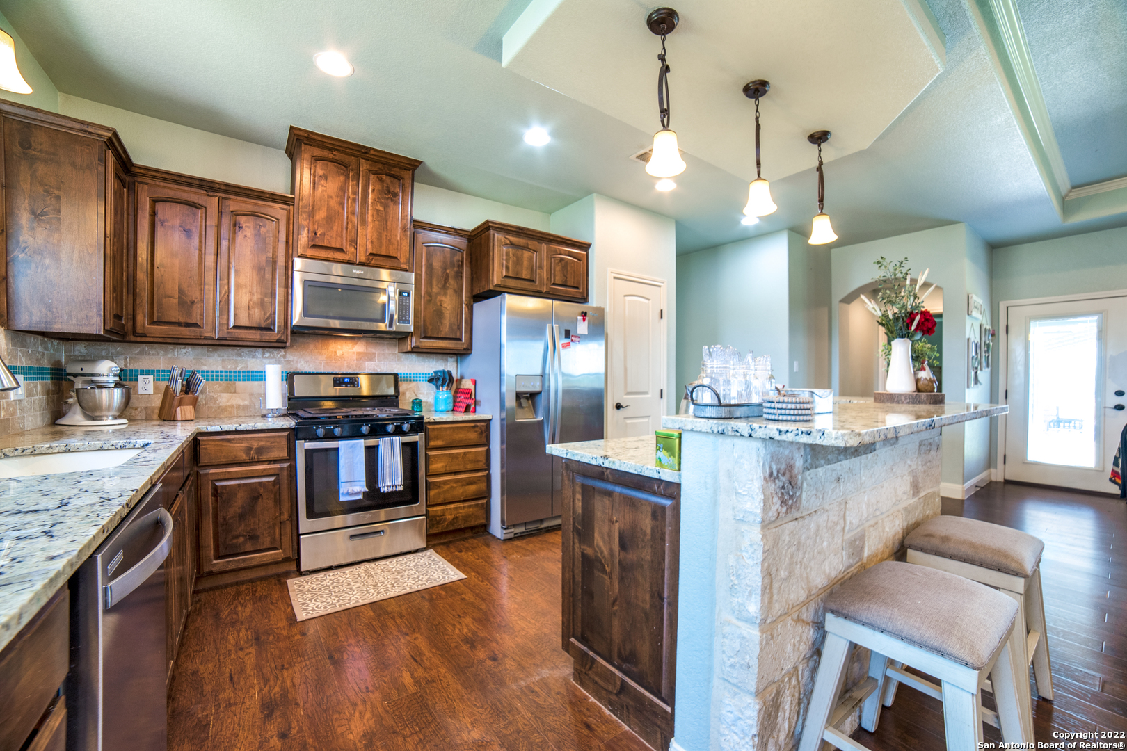 a kitchen with stainless steel appliances granite countertop a stove oven and a refrigerator