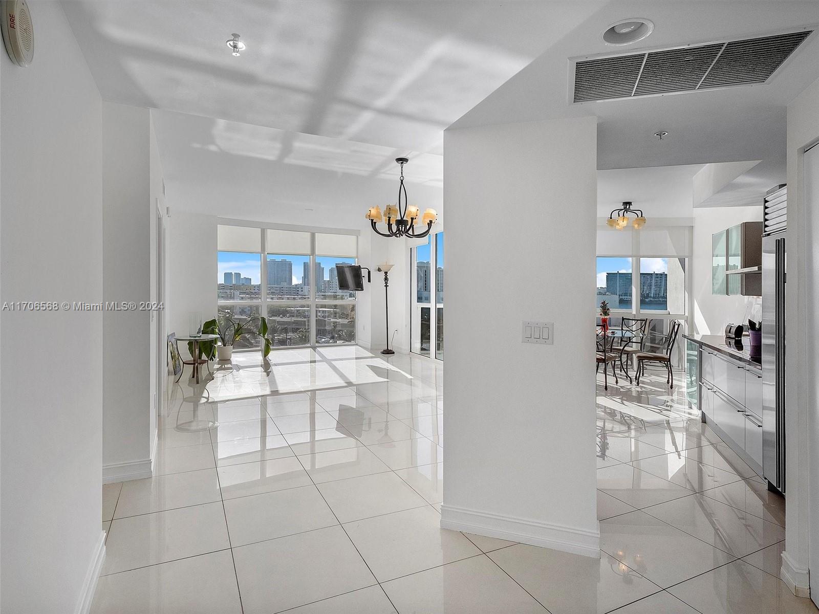 a living room with furniture a rug and white walls