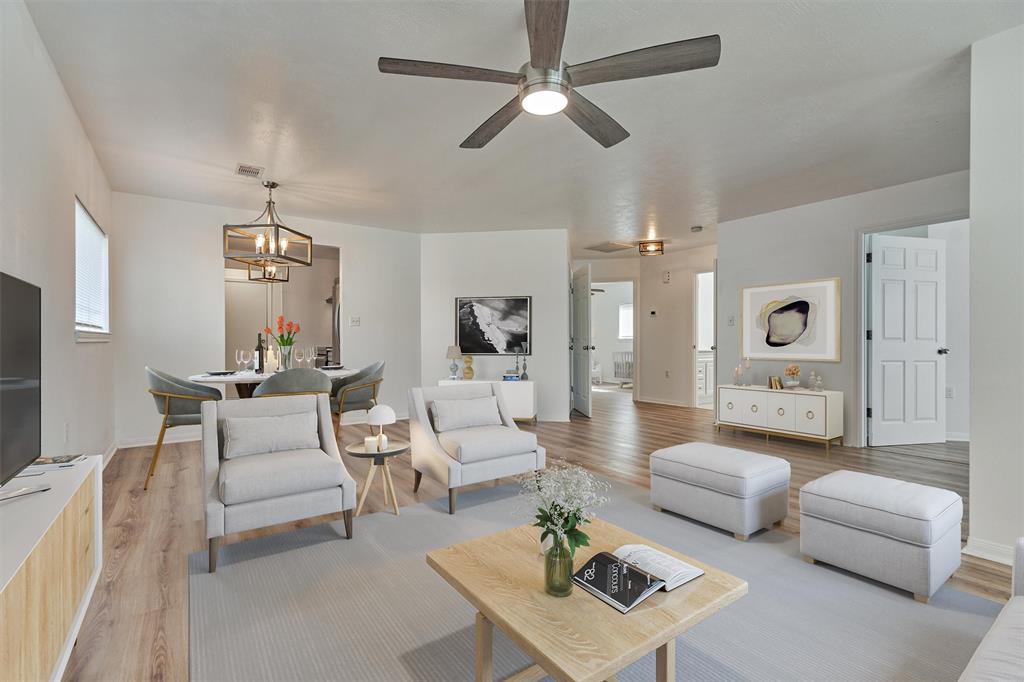 a living room with furniture and view of kitchen