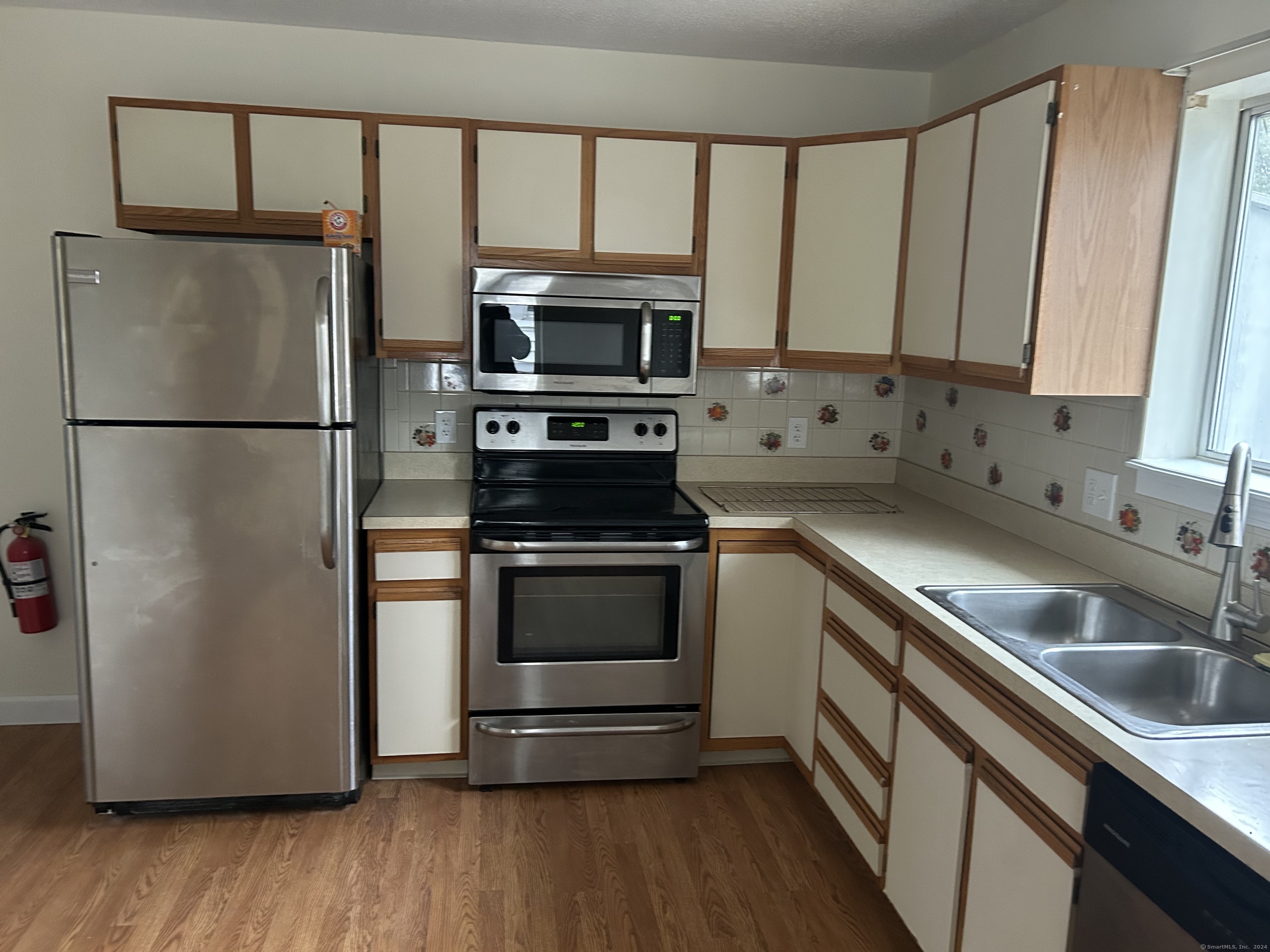 a kitchen with stainless steel appliances a refrigerator sink and microwave