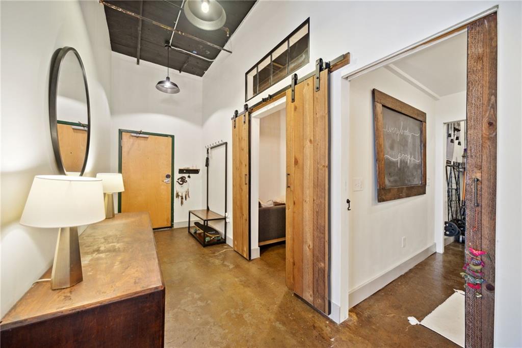 a spacious bathroom with a toilet sink and mirror