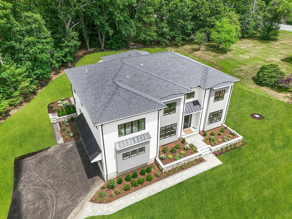 an aerial view of a house with a yard