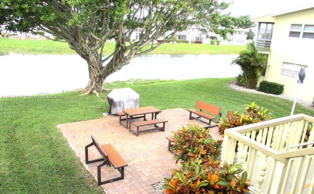 a view of a patio with table and chairs and garden