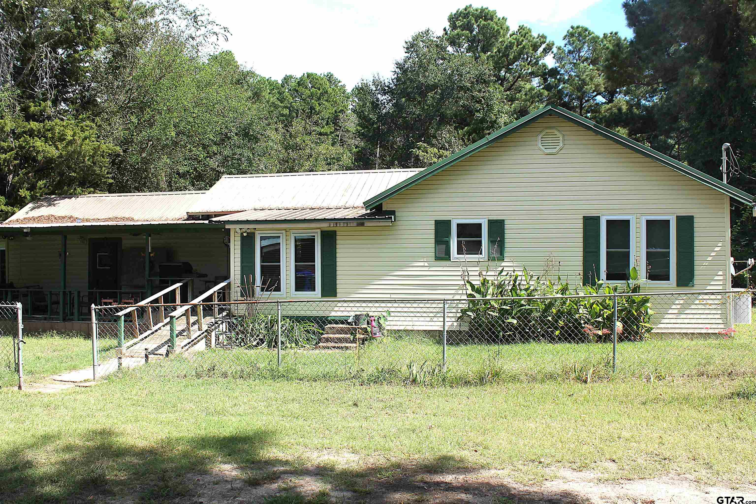 a view of house with a yard