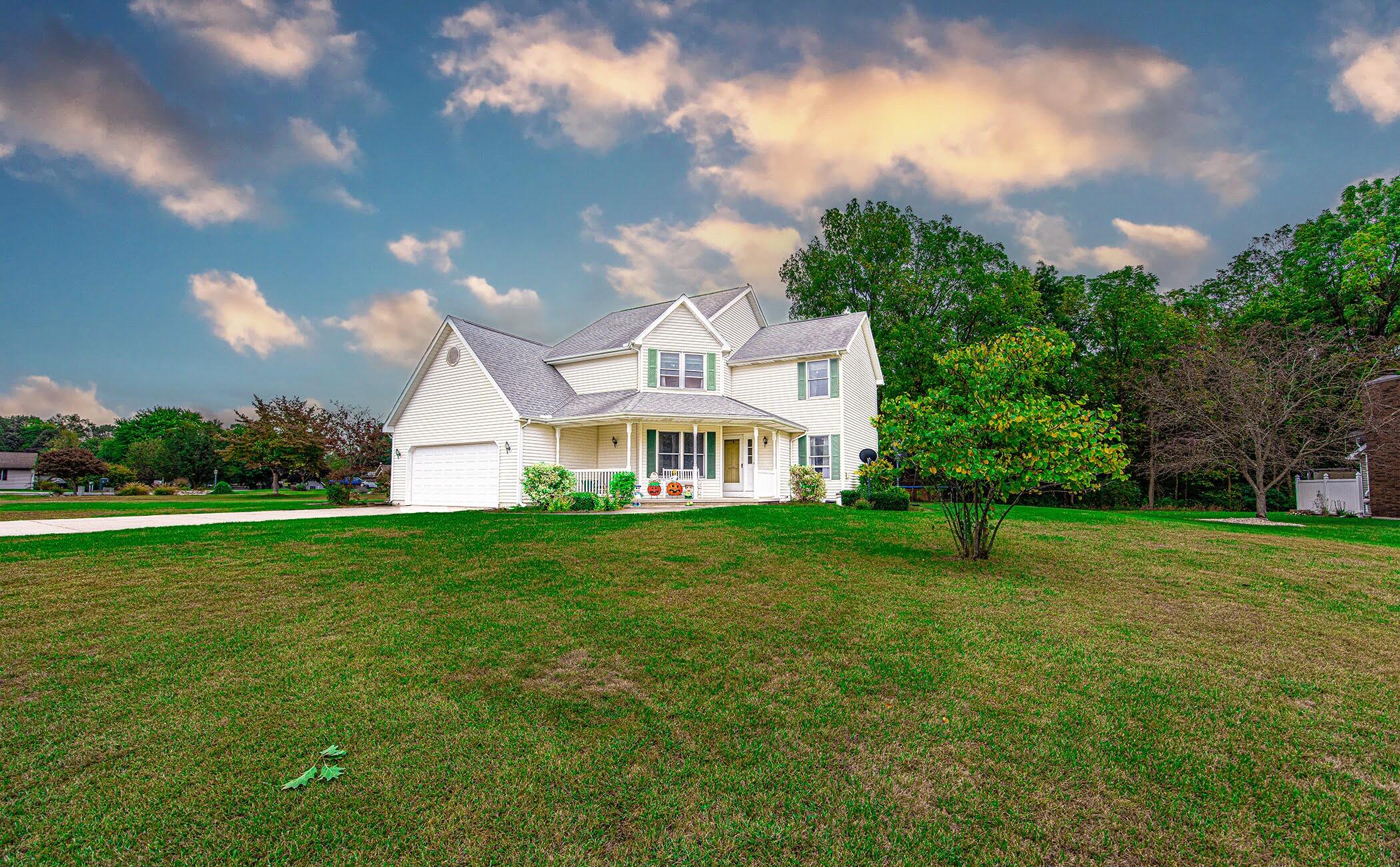 a front view of a house with garden