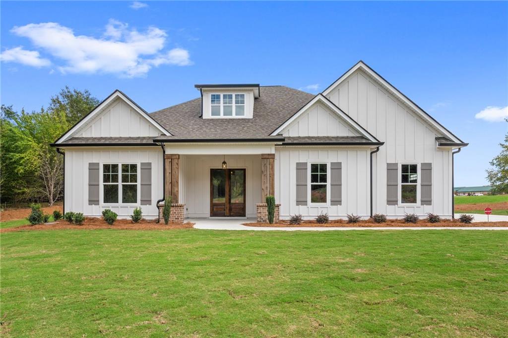 a front view of house with yard outdoor seating and green space