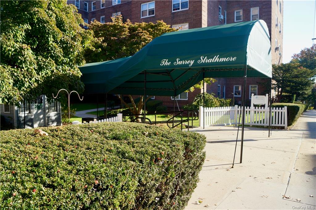 a view of a chairs and table in front of building