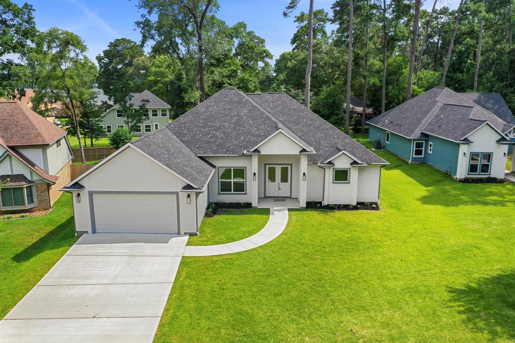 a front view of a house with yard and green space