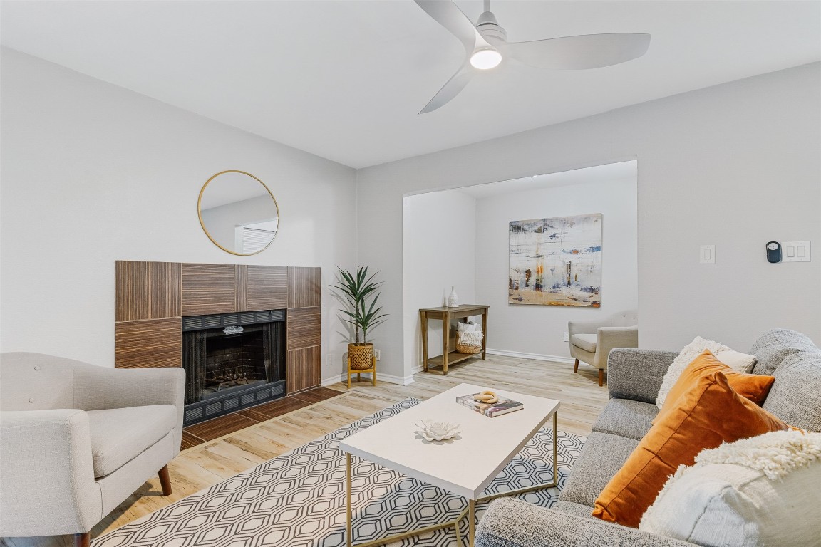 a living room with furniture a fireplace and a table