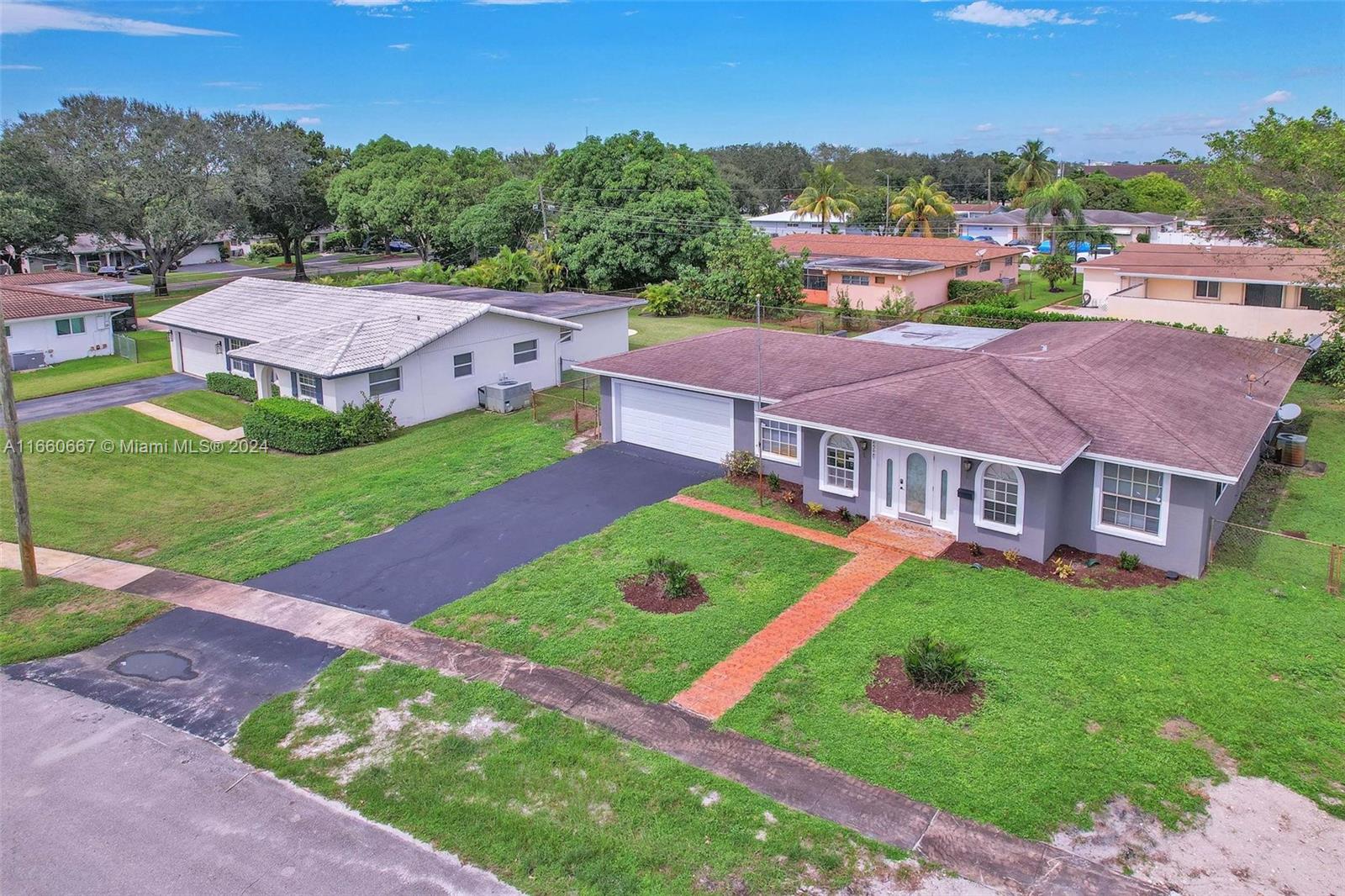 an aerial view of a house with a big yard