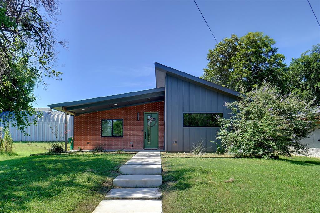 a front view of house with a garden