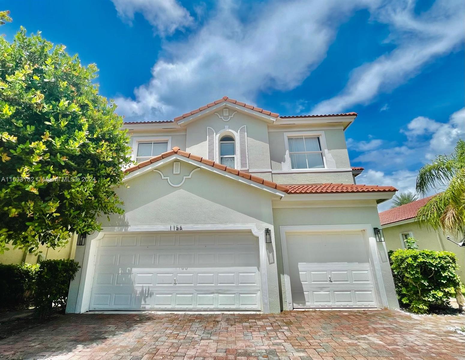 a front view of a house with a garage