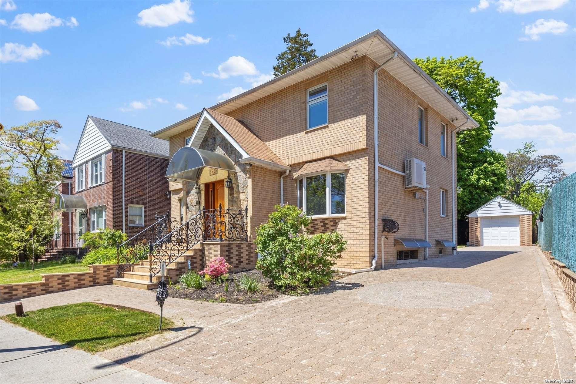 a front view of a house with a yard and potted plants