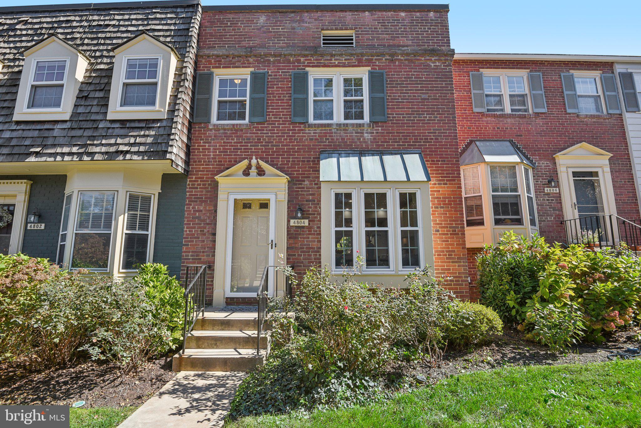 front view of a brick house with a large windows