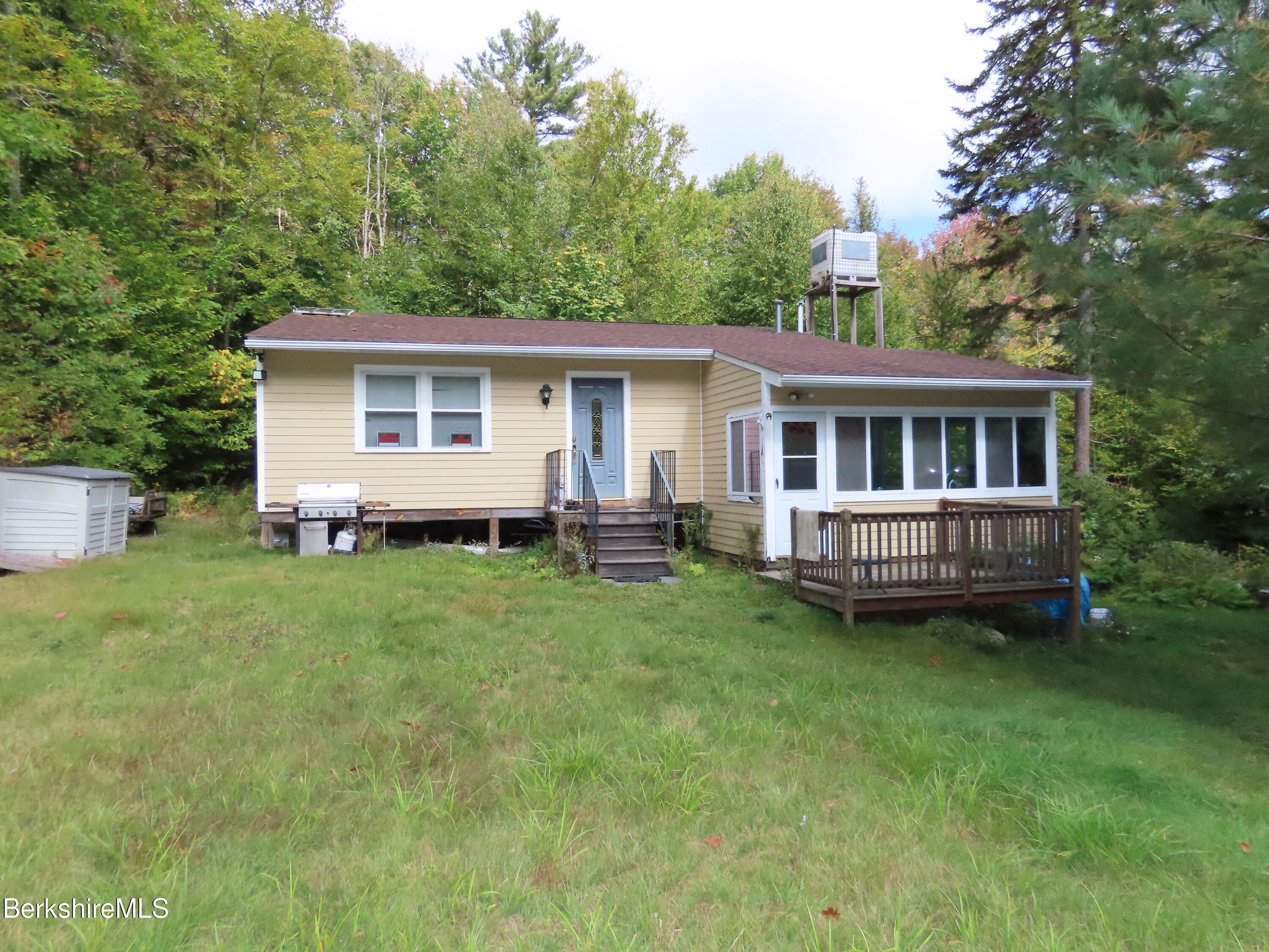 a view of a house with a backyard and a patio