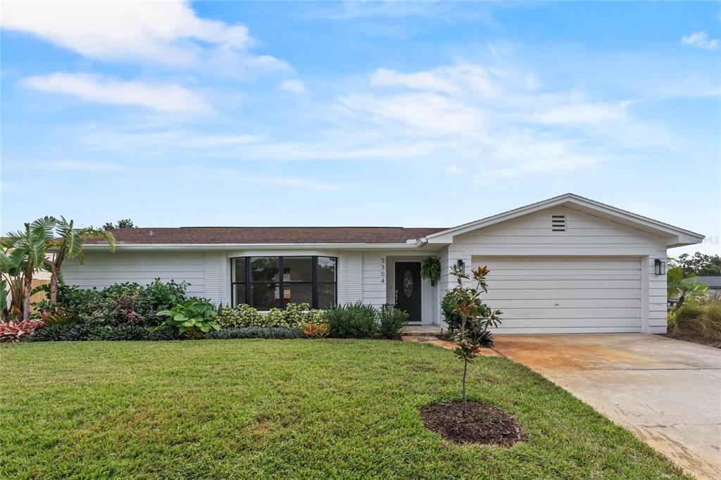 a front view of house with yard and green space