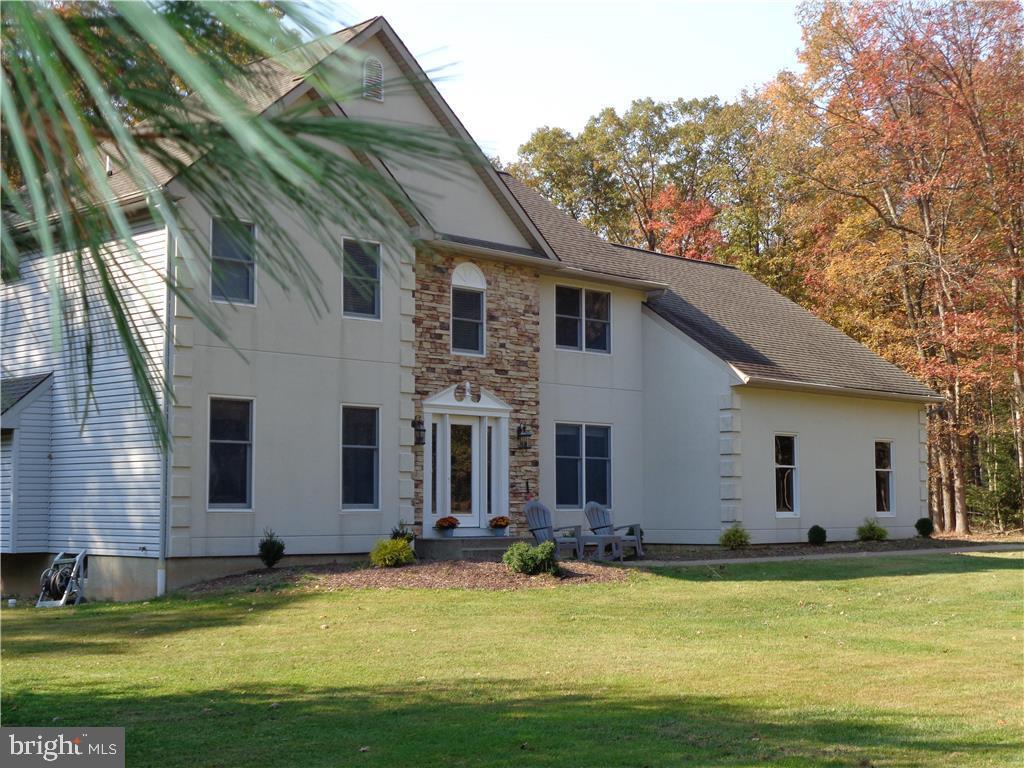 a view of a house with swimming pool and a yard