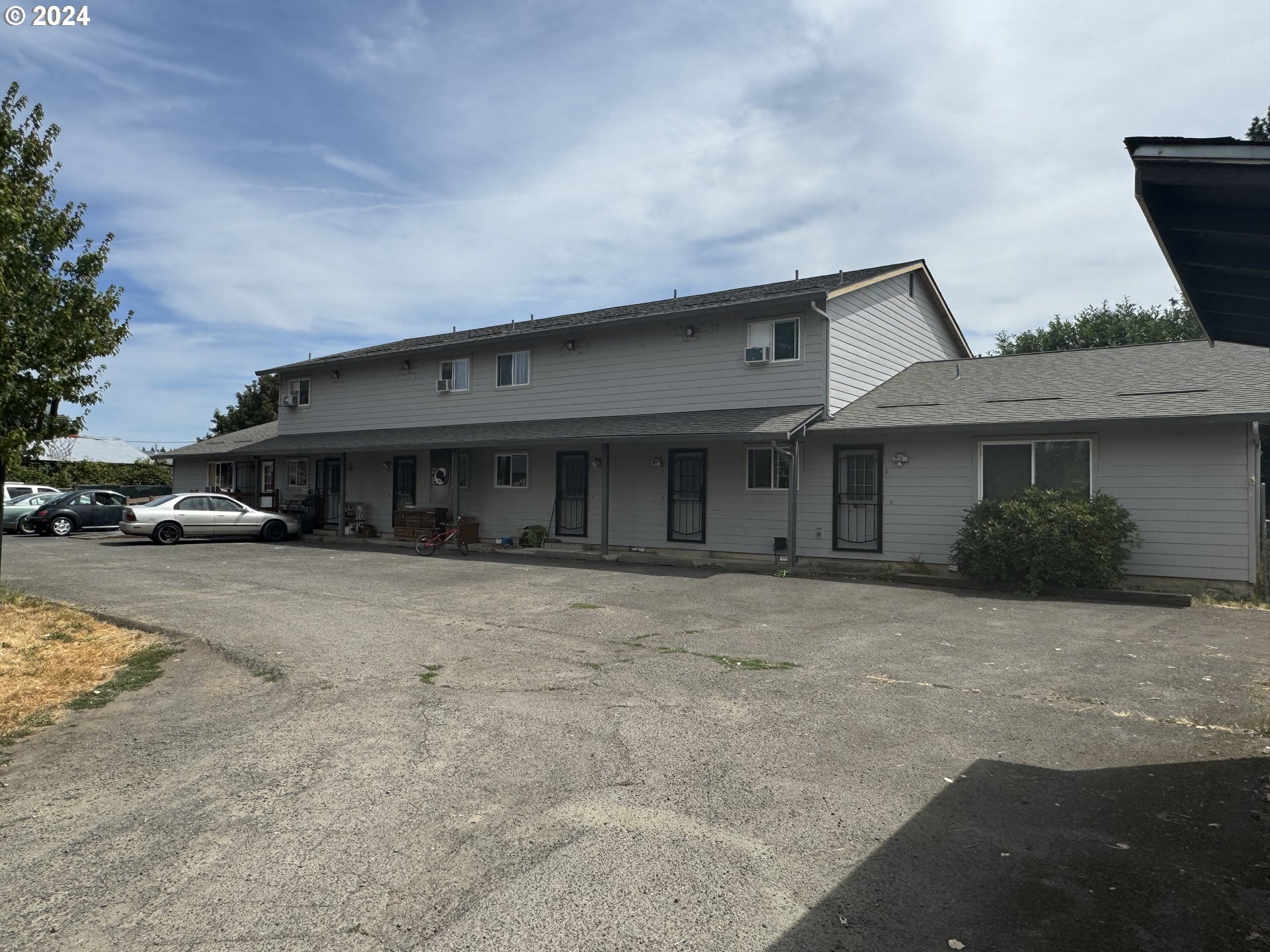 a front view of a house with a parking space