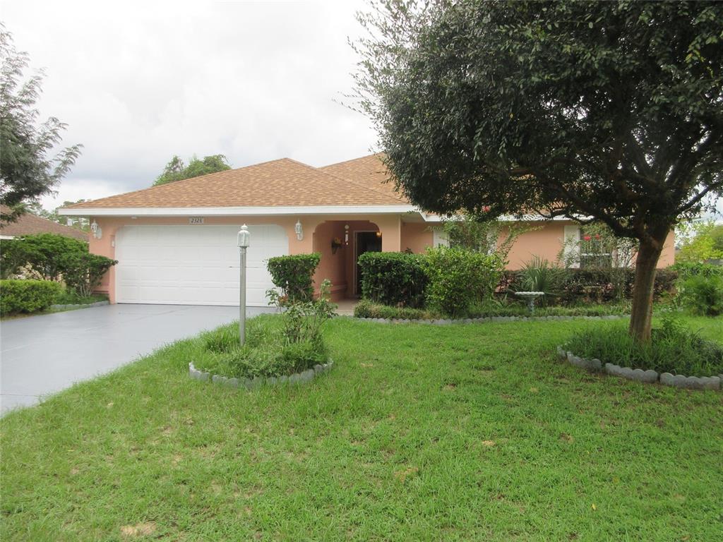 a front view of house with yard and green space