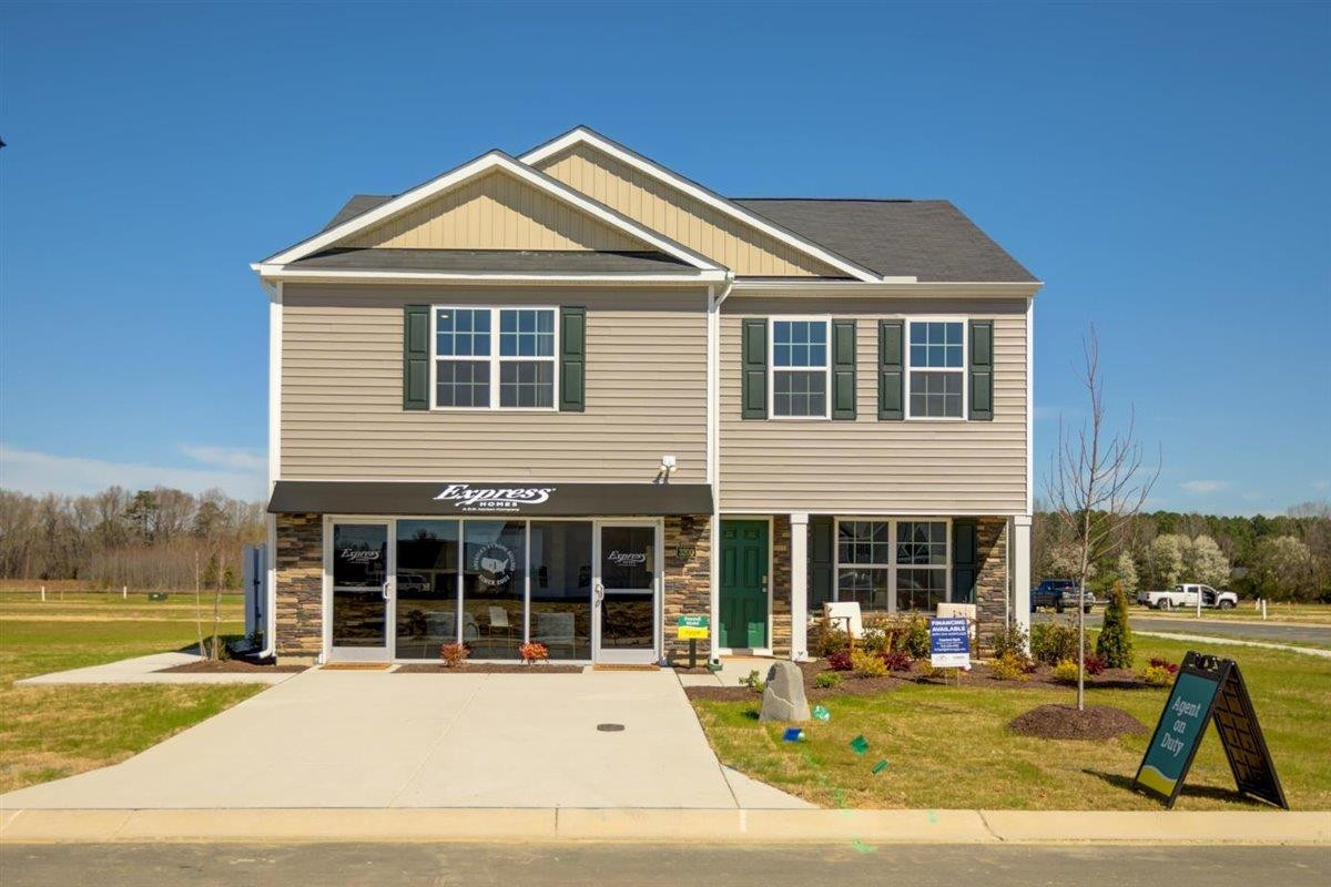 a front view of a house with a yard outdoor seating and kitchen view