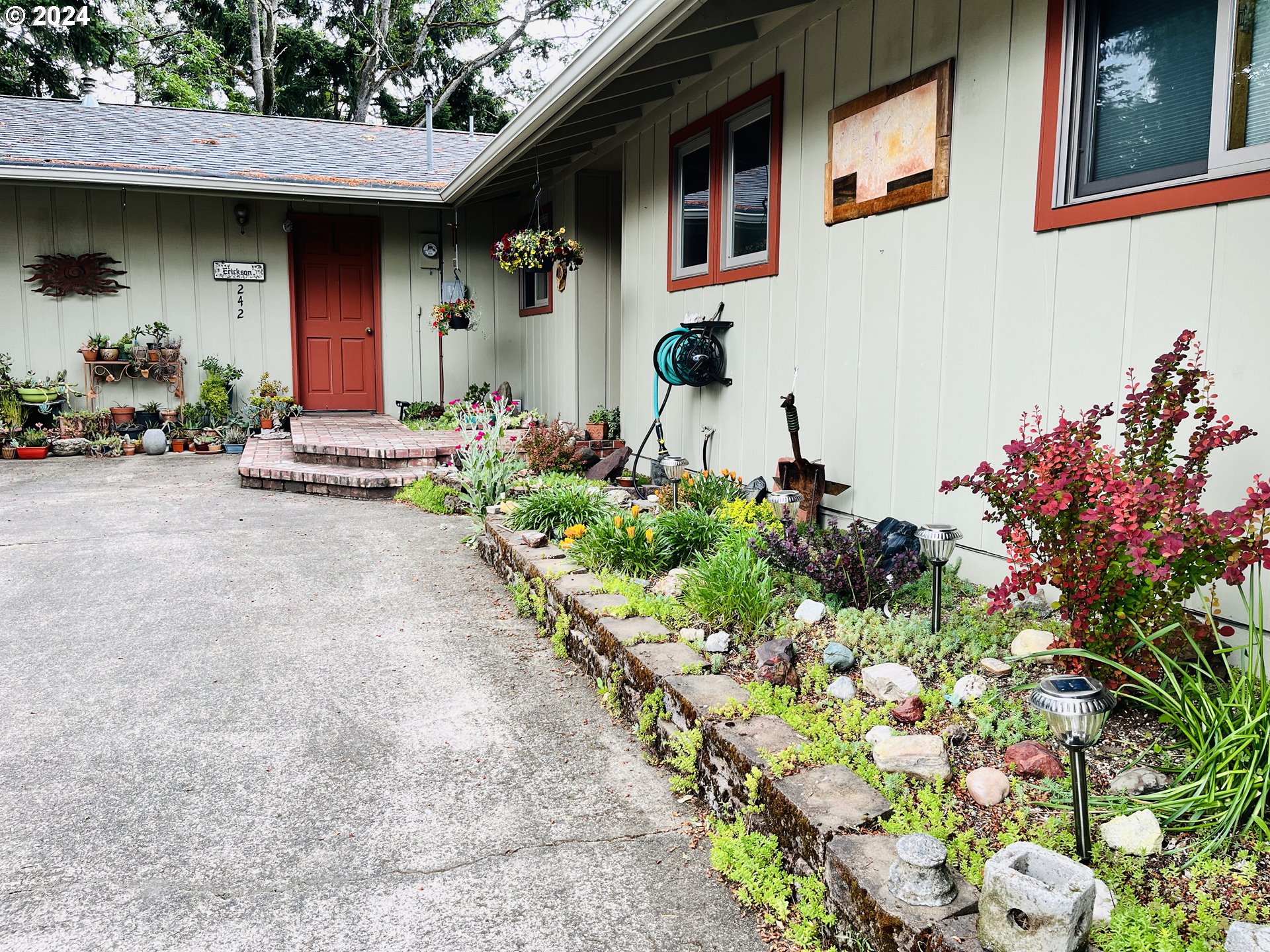 a front view of a house with a yard and flowers