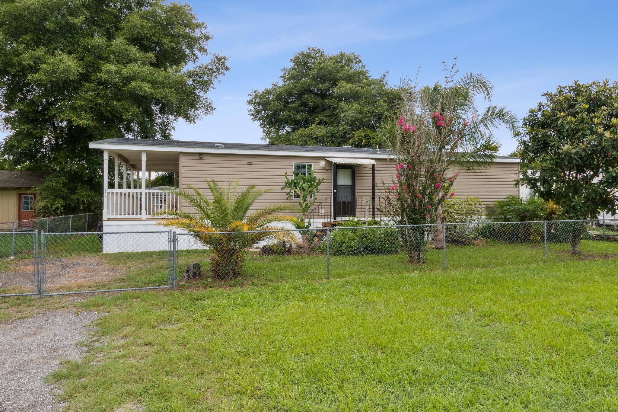 a view of a house with backyard and a garden