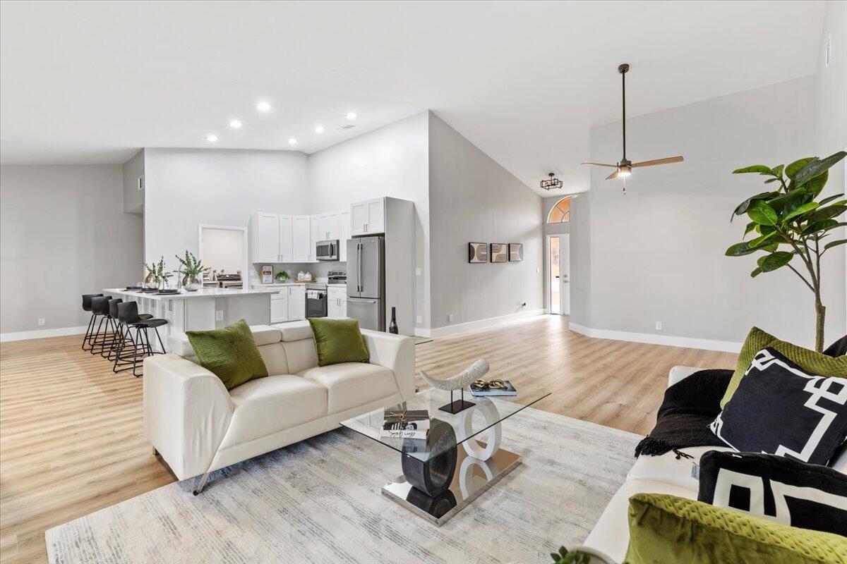 a living room with furniture and wooden floor