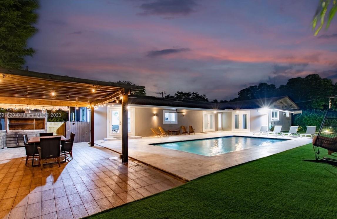 a view of a patio with swimming pool table and chairs