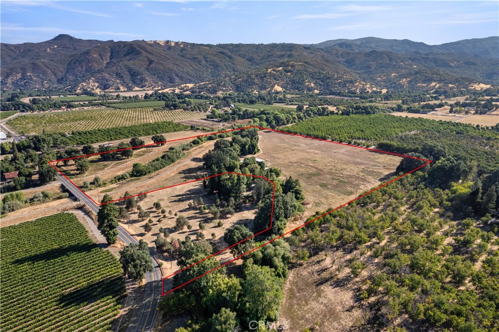 an aerial view of residential houses with outdoor space and river