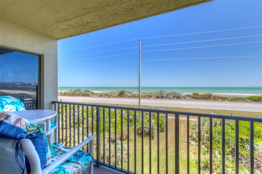 a view of a balcony with furniture