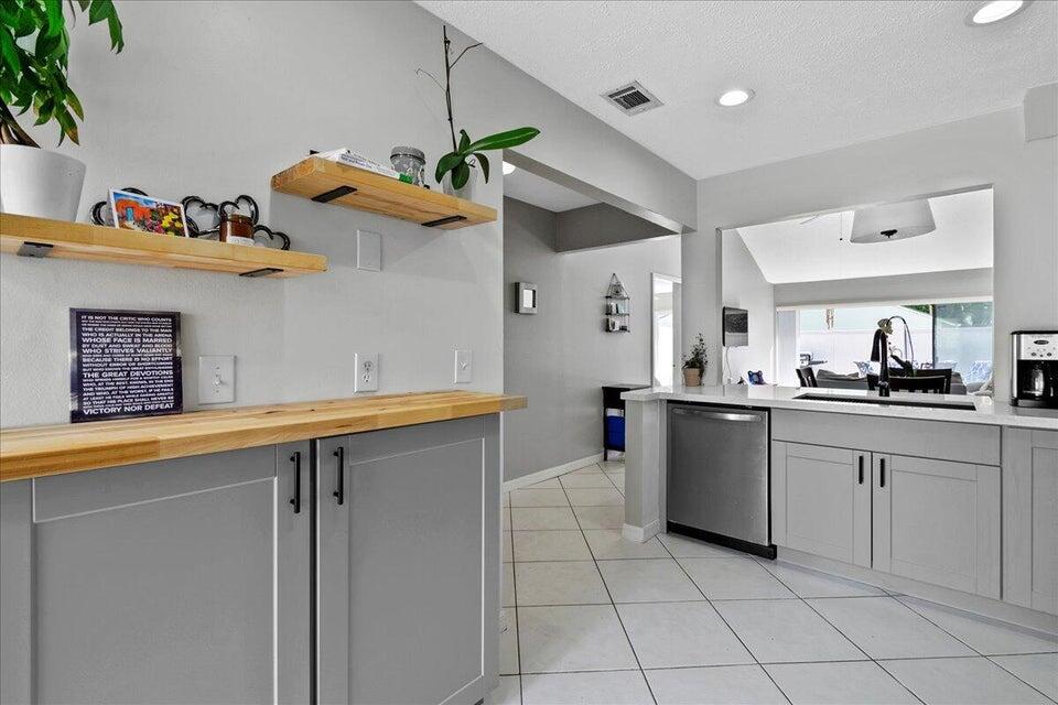 a kitchen with stainless steel appliances granite countertop a sink and cabinets