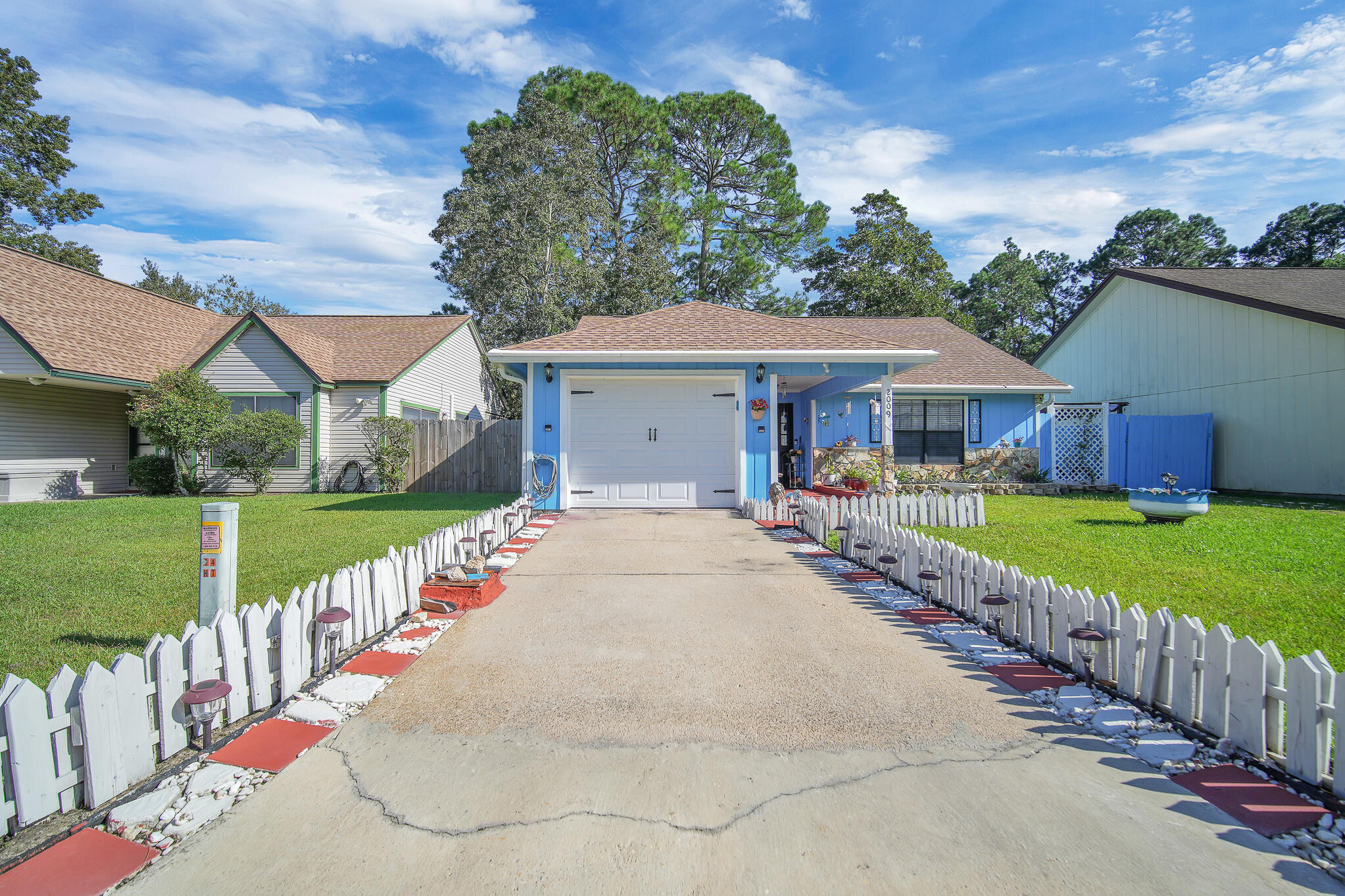 a front view of house with yard and green space