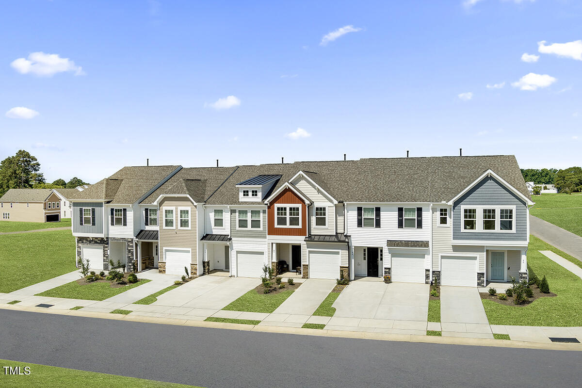 a view of multiple houses with a street