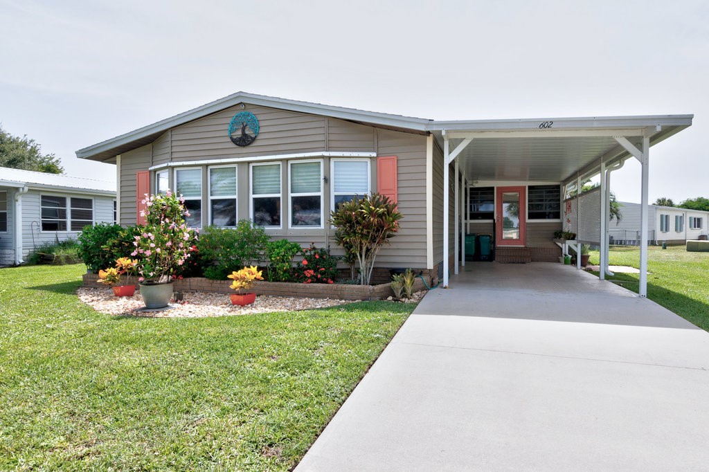 a front view of house with yard and green space