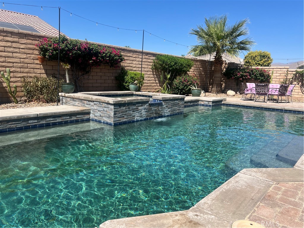 a view of swimming pool with a lounge chairs