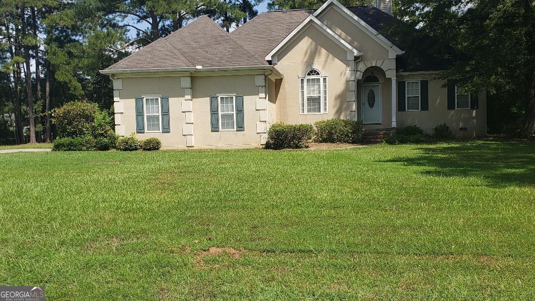 a front view of a house with a garden